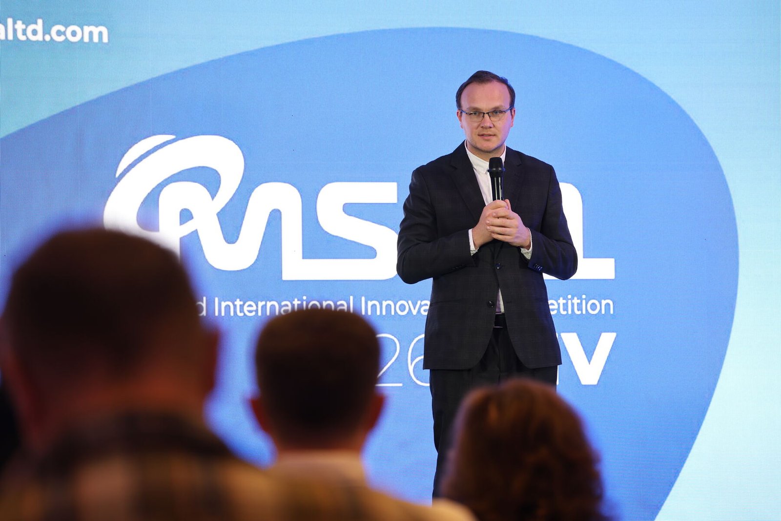 Denys Kurbatov addressing the audience with the MSCA logo behind him