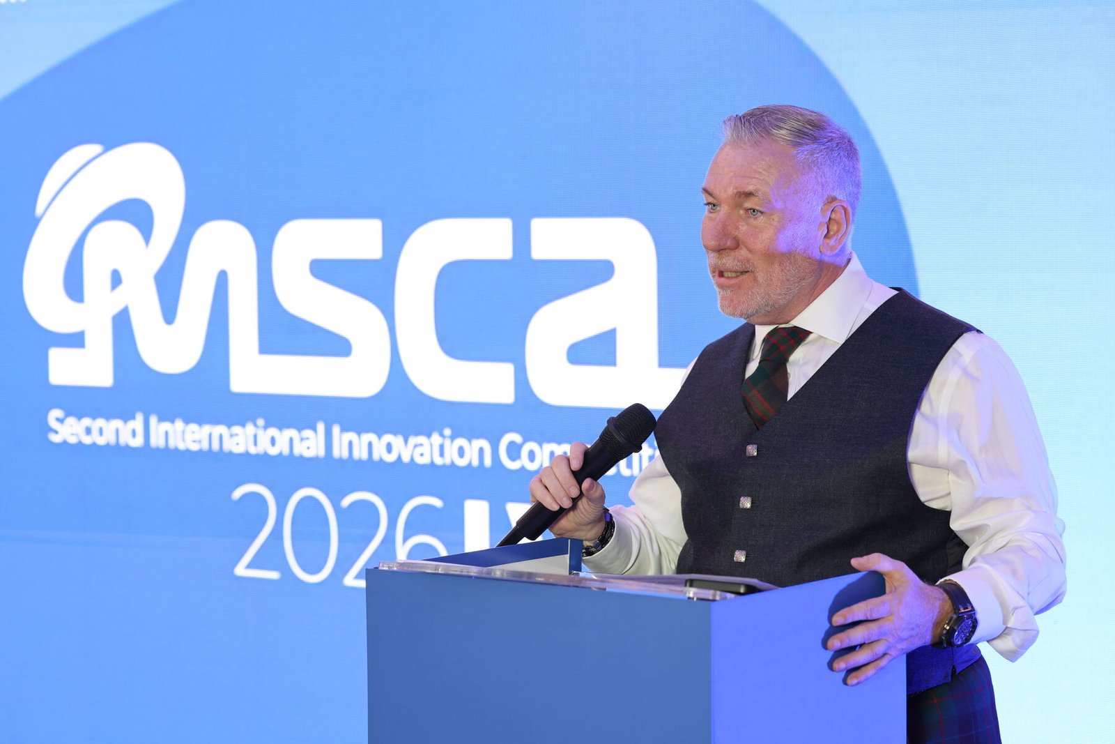 Stuart Ford speaking at the lectern in front of the MSCA logo